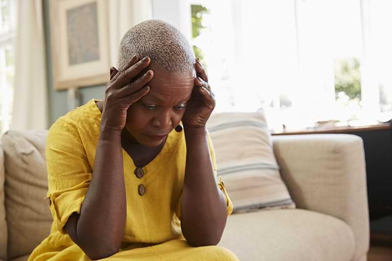 senior woman holding head